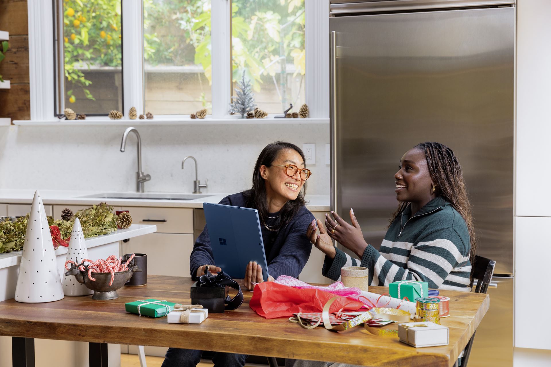 Two women sitting together in front of a computer screen